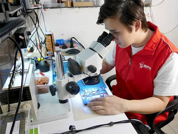 SPR technicians working on phone repairs at the workshop bench