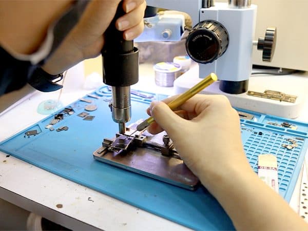 Technician replacing a component